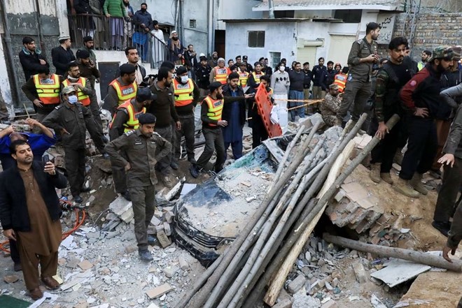 People and rescue workers gather amid the damages, after a suicide blast in a mosque in Peshawar, Pakistan January 30, 2023. REUTERS/Fayaz Aziz